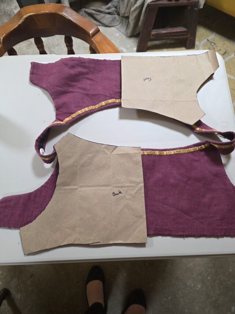 Brown Paper Bodice Pattern over the orginal bodice taken off the skirt.